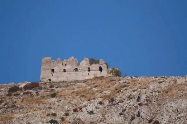 Le mura in rovina della Rocca sulla cima del Monte Petrino, viste dal basso contro il cielo
